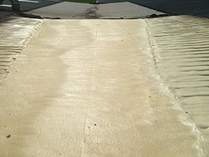 Close-up of a light tan concrete surface with ridged edges on both sides and a central seam, like a walkway or ramp.